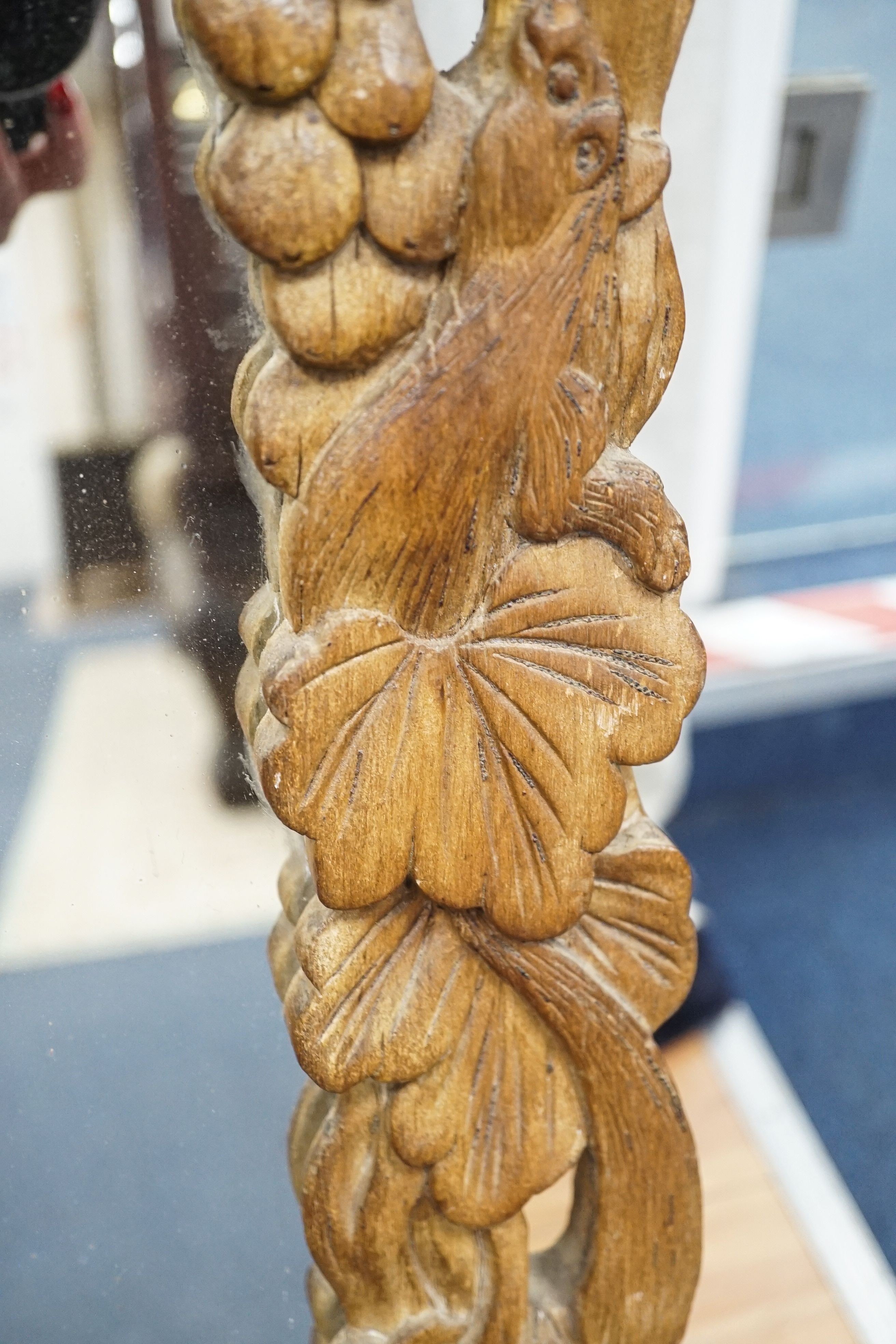 A Japanese 'squirrel and vine' rectangular carved wood mirror, width 57cm, height 96cm